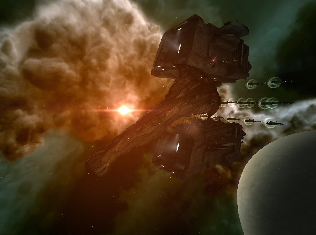 An Avatar-class Titan rendered in the 2006-era engine, golden engine glow on the rear with a planet to lower right and nebula clouds; the canonical unveiling shot CCP shipped at the 10-year mark